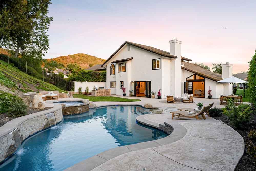 A Luxurious Backyard With A Swimming Pool Hot Tub